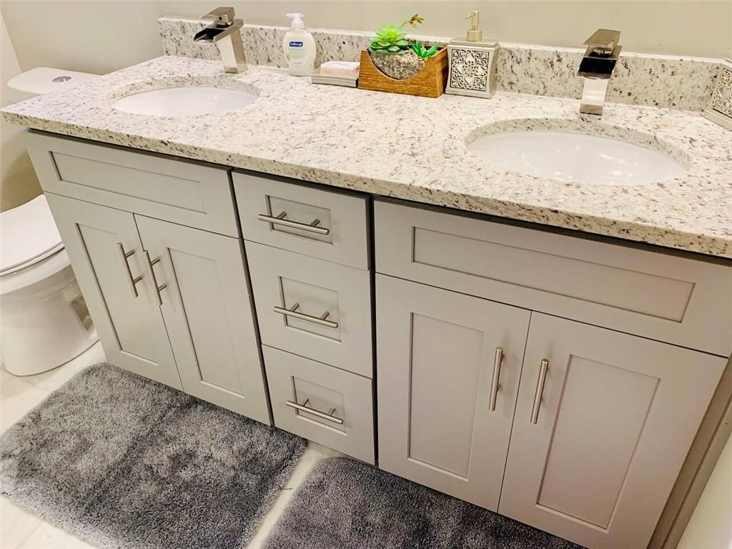 2130 Seavey Drive Decatur, GA 30032 - Photo 12 of 16 a bathroom with a granite countertop sink and a mirror
