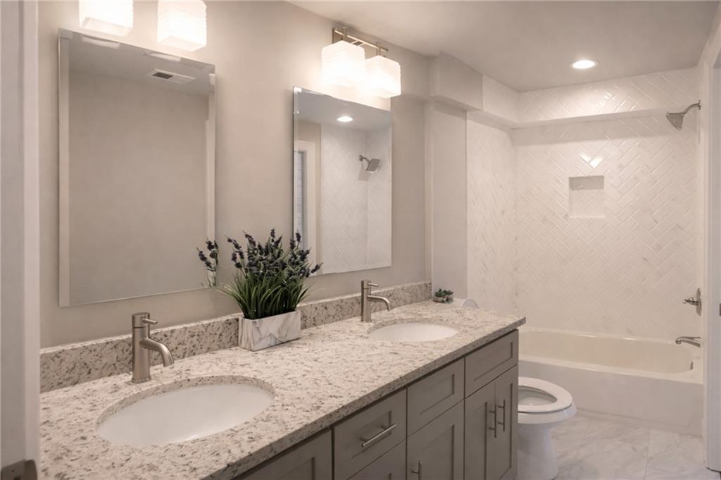 2130 Seavey Drive Decatur, GA 30032 - Photo 14 of 16 a bathroom with a granite countertop sink toilet and shower