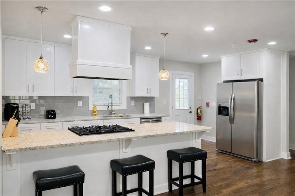 2130 Seavey Drive Decatur, GA 30032 - Photo 6 of 16 a kitchen with refrigerator a sink and chairs