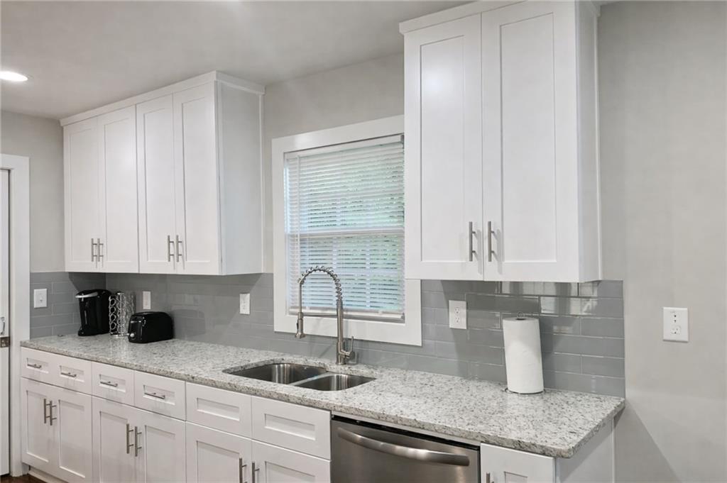 2130 Seavey Drive Decatur, GA 30032 - Photo 7 of 16 a kitchen with granite countertop a sink a stove and cabinets