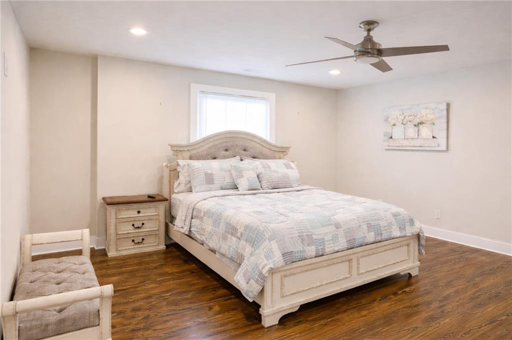 2130 Seavey Drive Decatur, GA 30032 - Photo 8 of 16 a bedroom with a bed and a chandelier