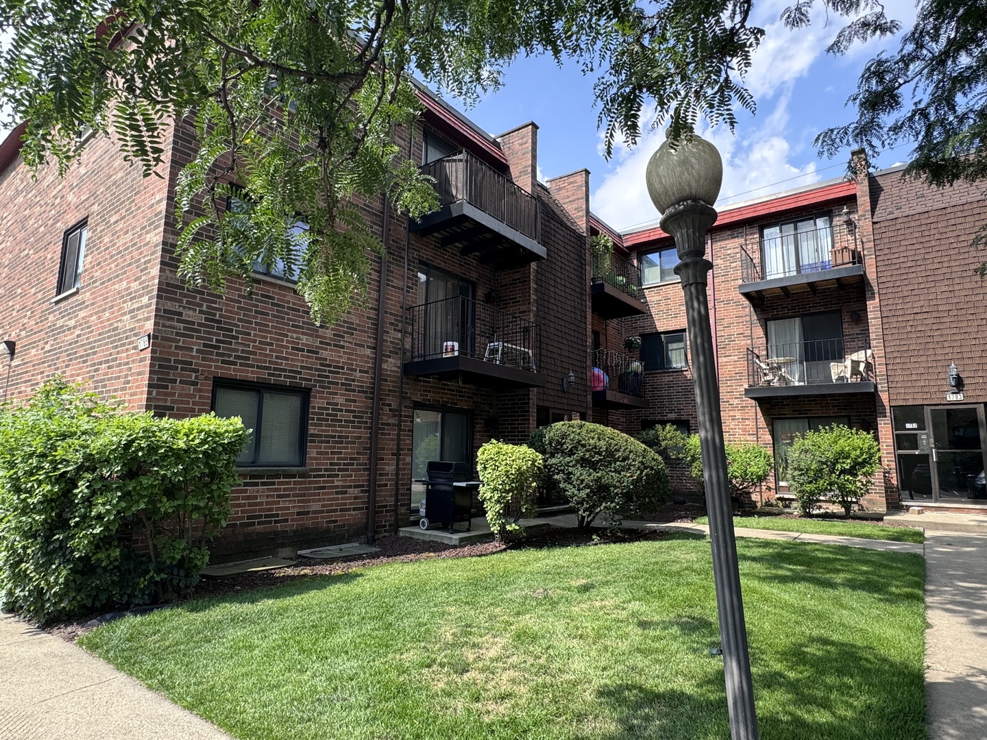 1785 West Algonquin Road, Unit 2A Mount Prospect, IL 60056 - Photo 3 of 14 a front view of a house with garden