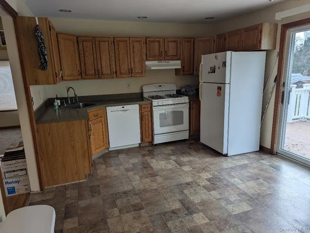 a kitchen with a refrigerator sink and cabinets