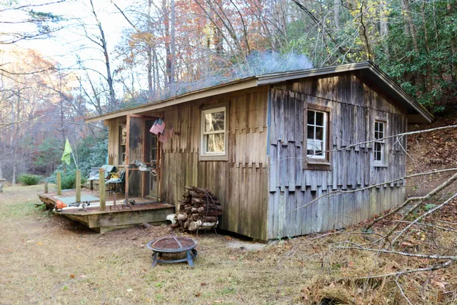 a backyard of a house with yard fire pit and outdoor seating