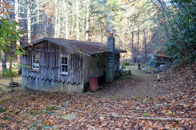 a view of a wooden house with a yard