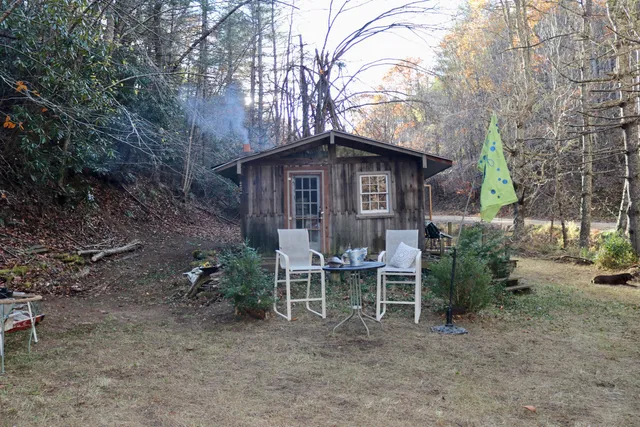 a view of a chair and table in backyard