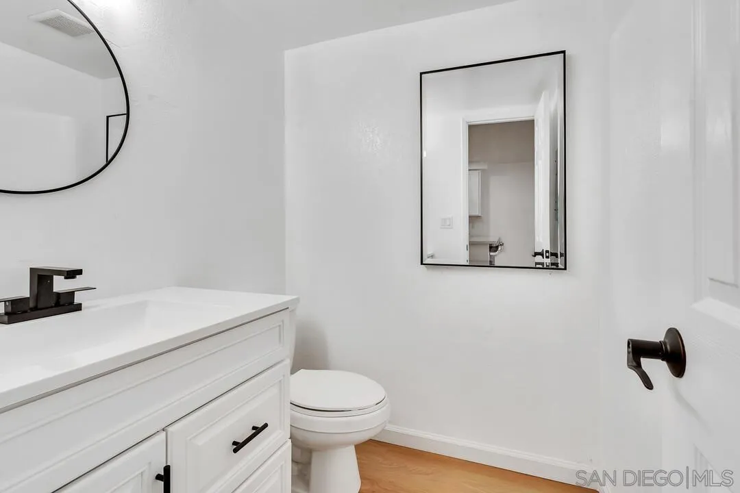 12027 Royal Road, Unit 3 El Cajon, CA 92021 - Photo 11 of 30 a bathroom with a sink a toilet and a mirror