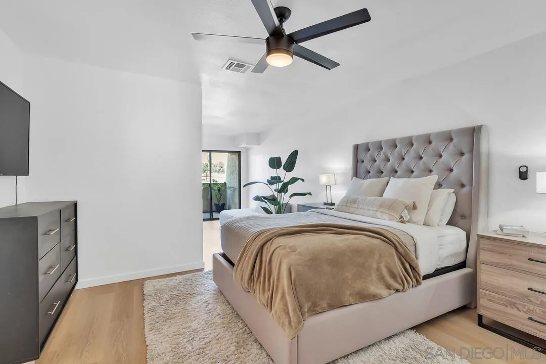 12027 Royal Road, Unit 3 El Cajon, CA 92021 - Photo 12 of 30 a bedroom with a large bed and a chandelier