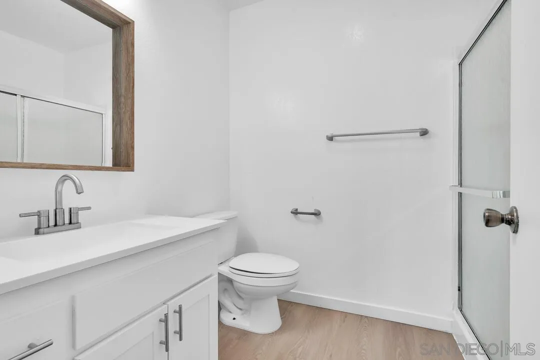 12027 Royal Road, Unit 3 El Cajon, CA 92021 - Photo 16 of 30 a bathroom with a toilet sink and a mirror