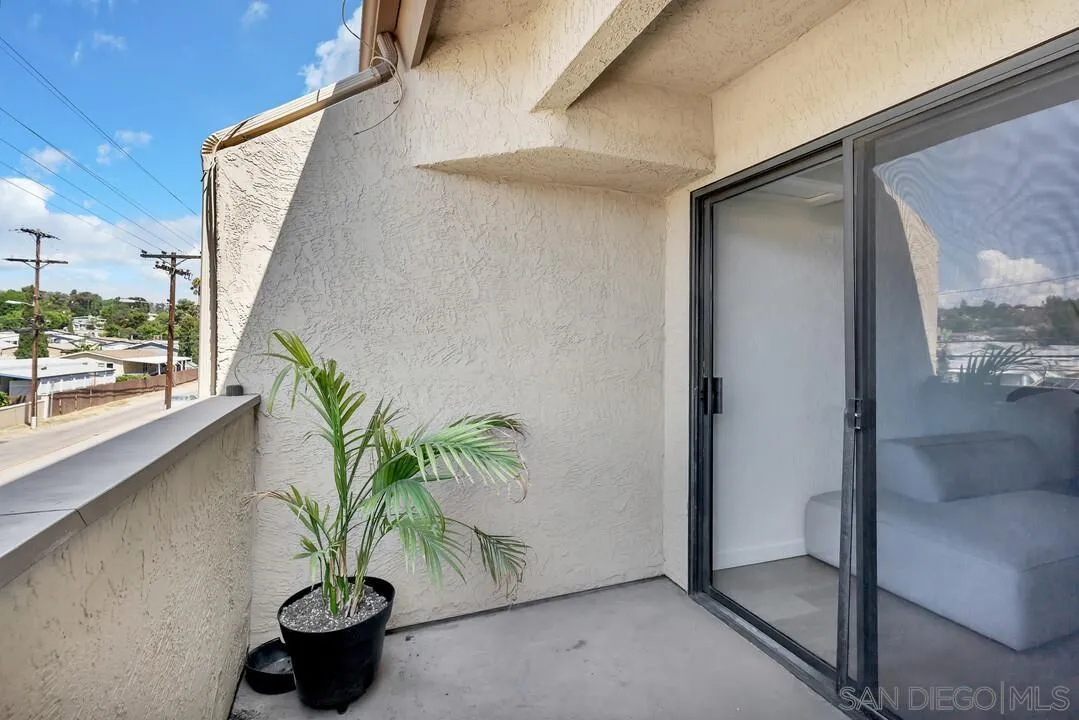 12027 Royal Road, Unit 3 El Cajon, CA 92021 - Photo 18 of 30 a potted plant sitting in front of a glass door