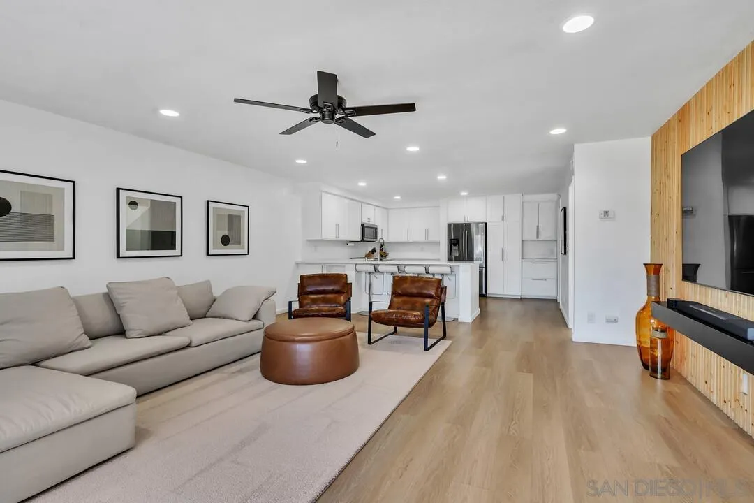 12027 Royal Road, Unit 3 El Cajon, CA 92021 - Photo 2 of 30 a living room with furniture kitchen view and a wooden floor