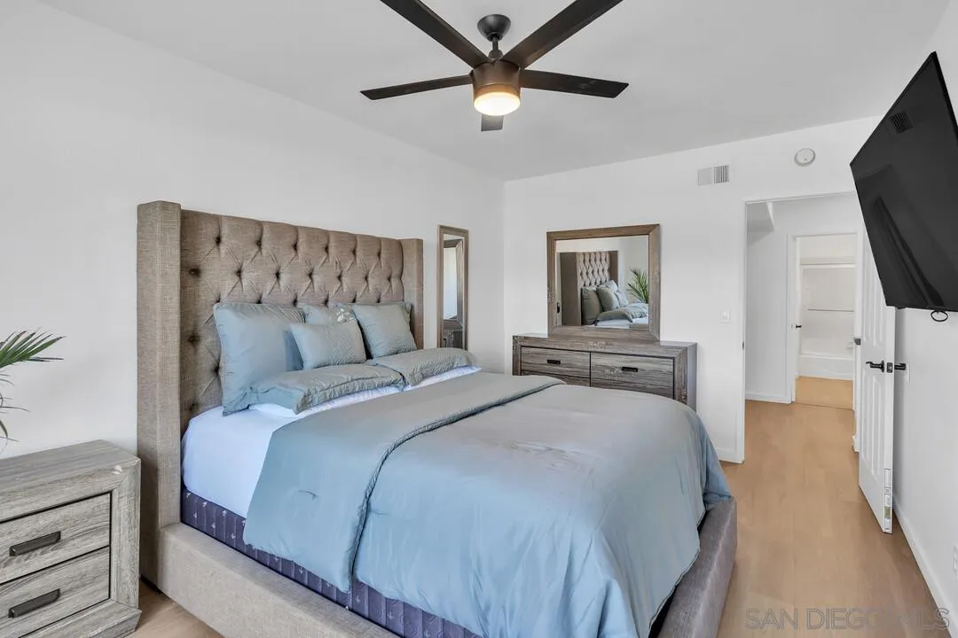 12027 Royal Road, Unit 3 El Cajon, CA 92021 - Photo 21 of 30 a bedroom with a bed and a flat tv screen on dresser