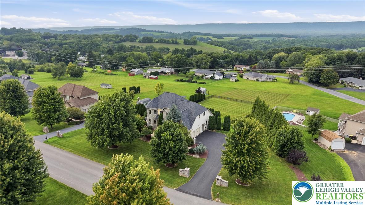 245 East Dell Road Bath, PA 18014 - Photo 91 of 99 An aerial perspective reveals a grand residence nestled amongst verdant hills, featuring an inviting private pool.