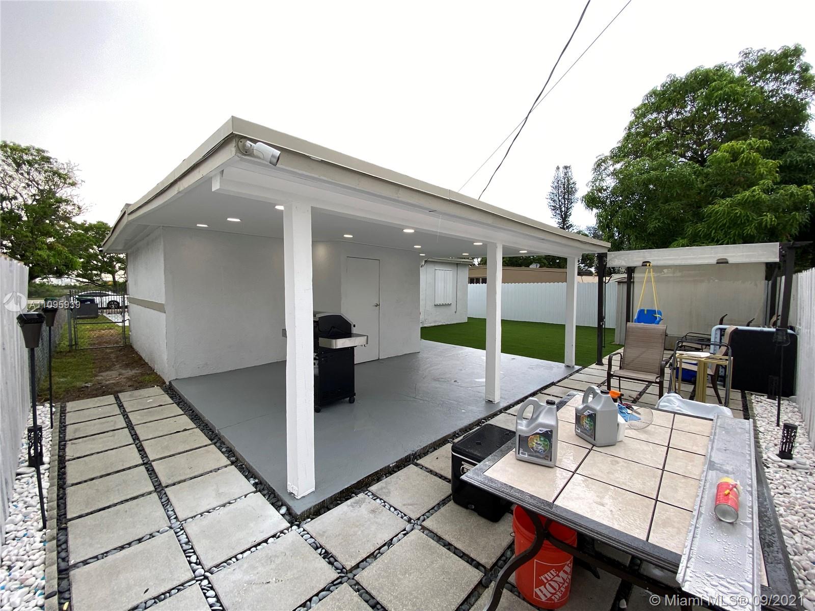 2380 Service Road Opa-Locka, FL 33054 - Photo 8 of 22 a view of a patio with table and chairs and potted plants