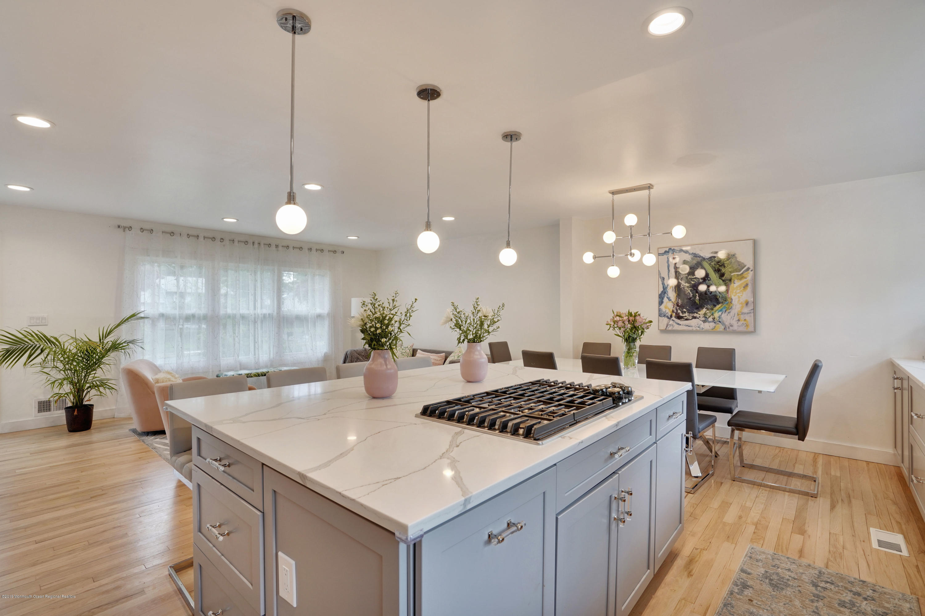 a kitchen with a table a stove and cabinets