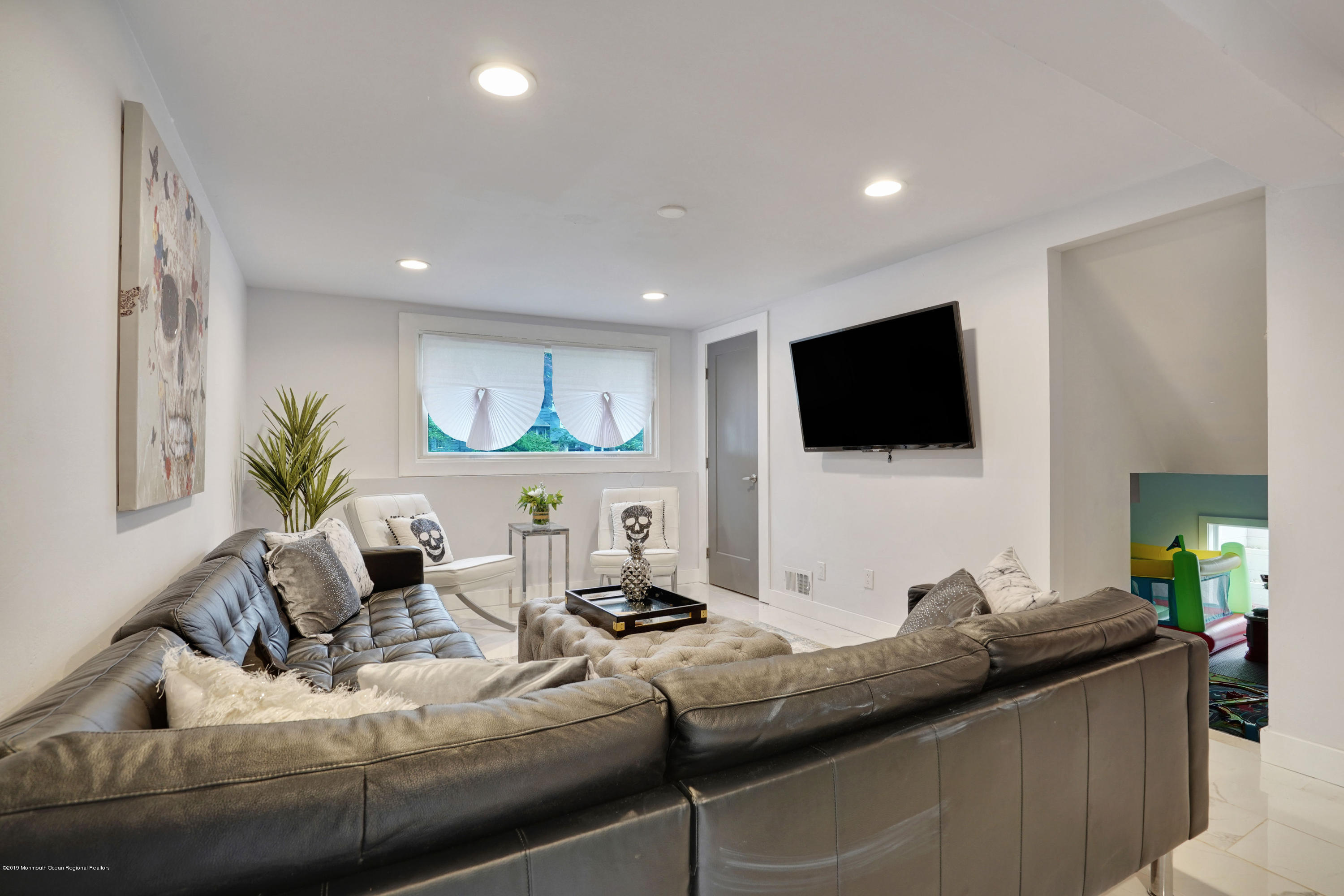 5 Ash Street Eatontown, NJ 07724 - Photo 12 of 31 a living room with furniture and a flat screen tv