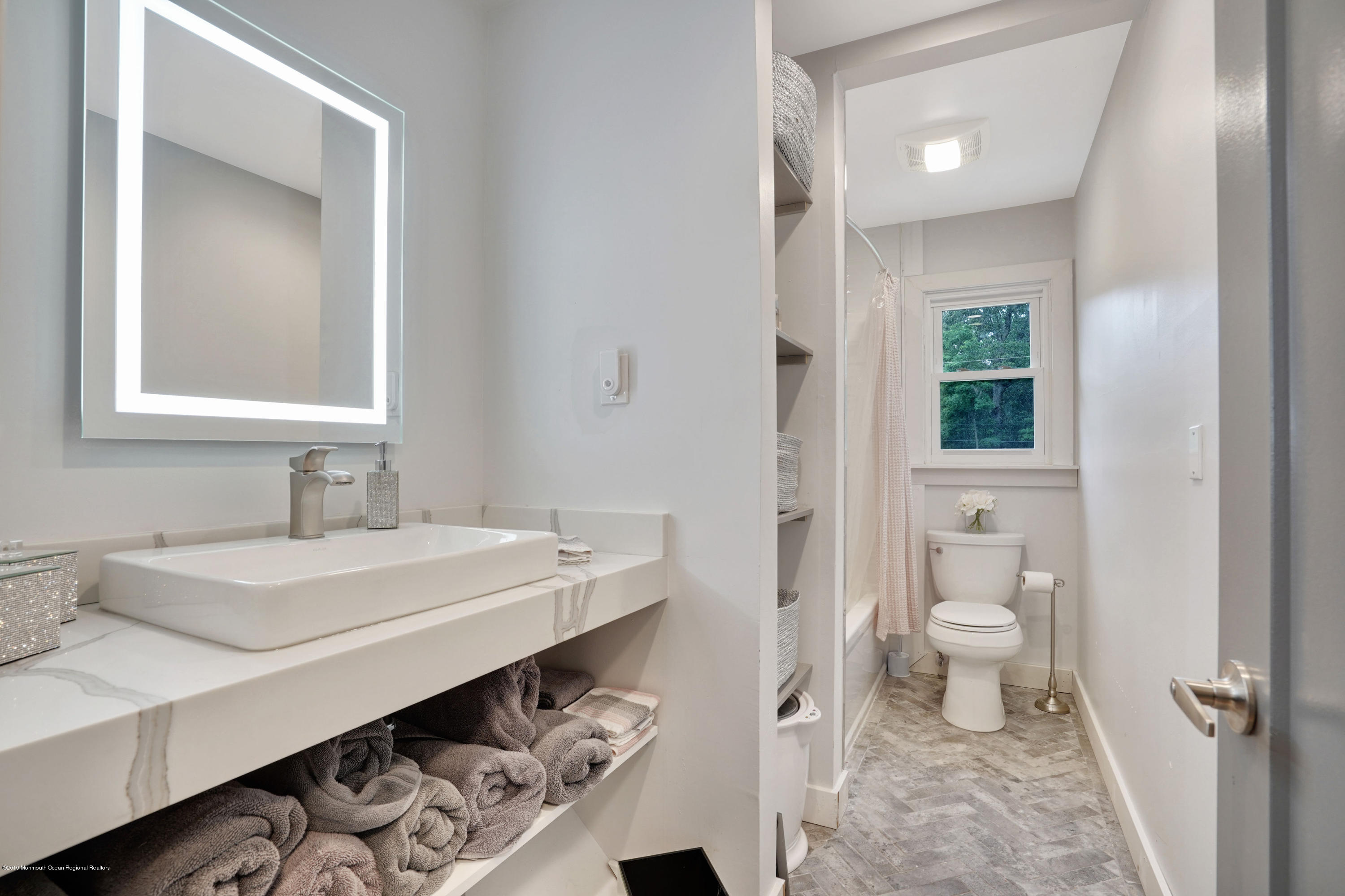 5 Ash Street Eatontown, NJ 07724 - Photo 13 of 31 a bathroom with a sink a toilet and a mirror