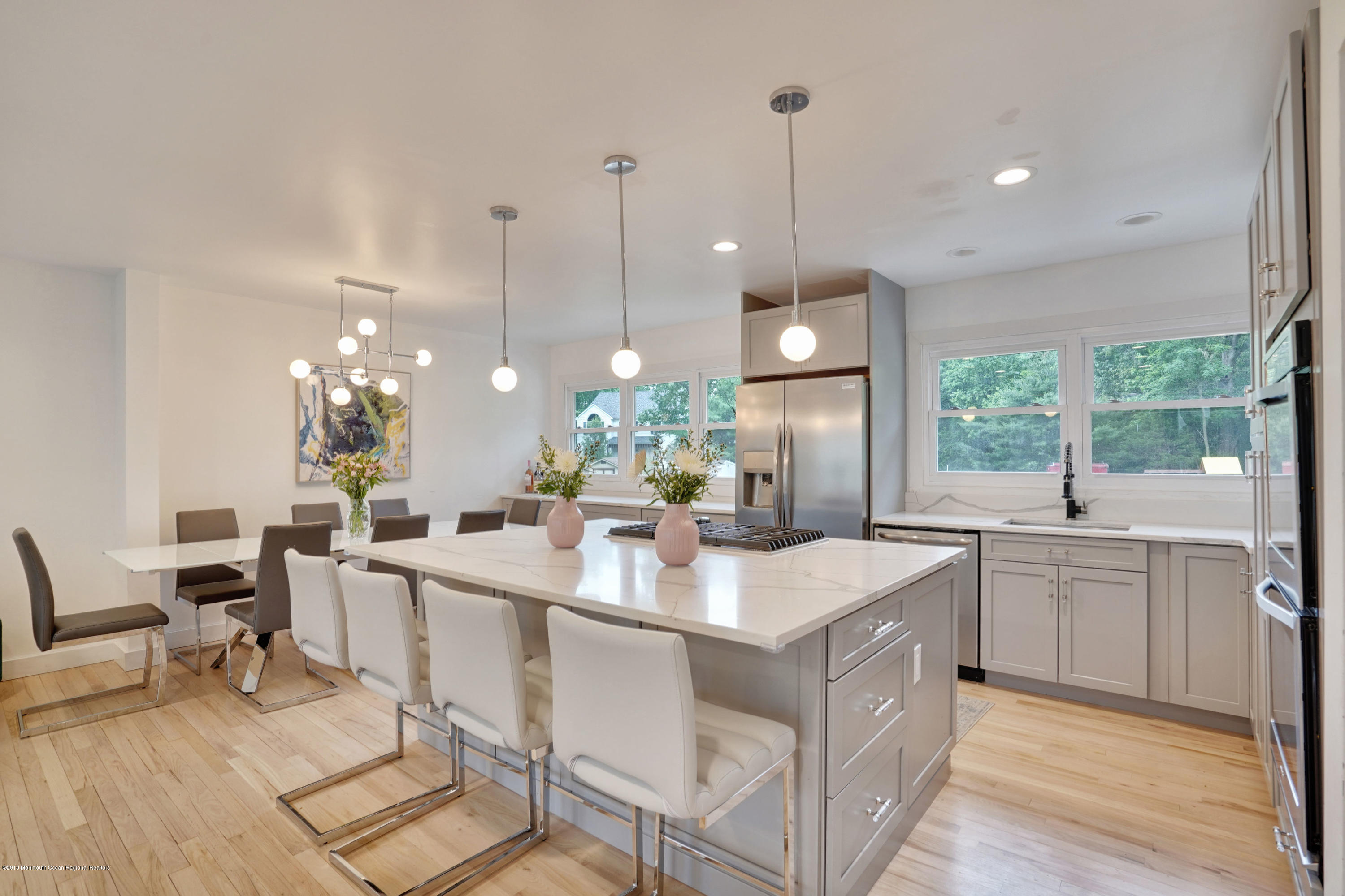 5 Ash Street Eatontown, NJ 07724 - Photo 2 of 31 a large white kitchen with a large island in the center a sink stainless steel appliances and a large window