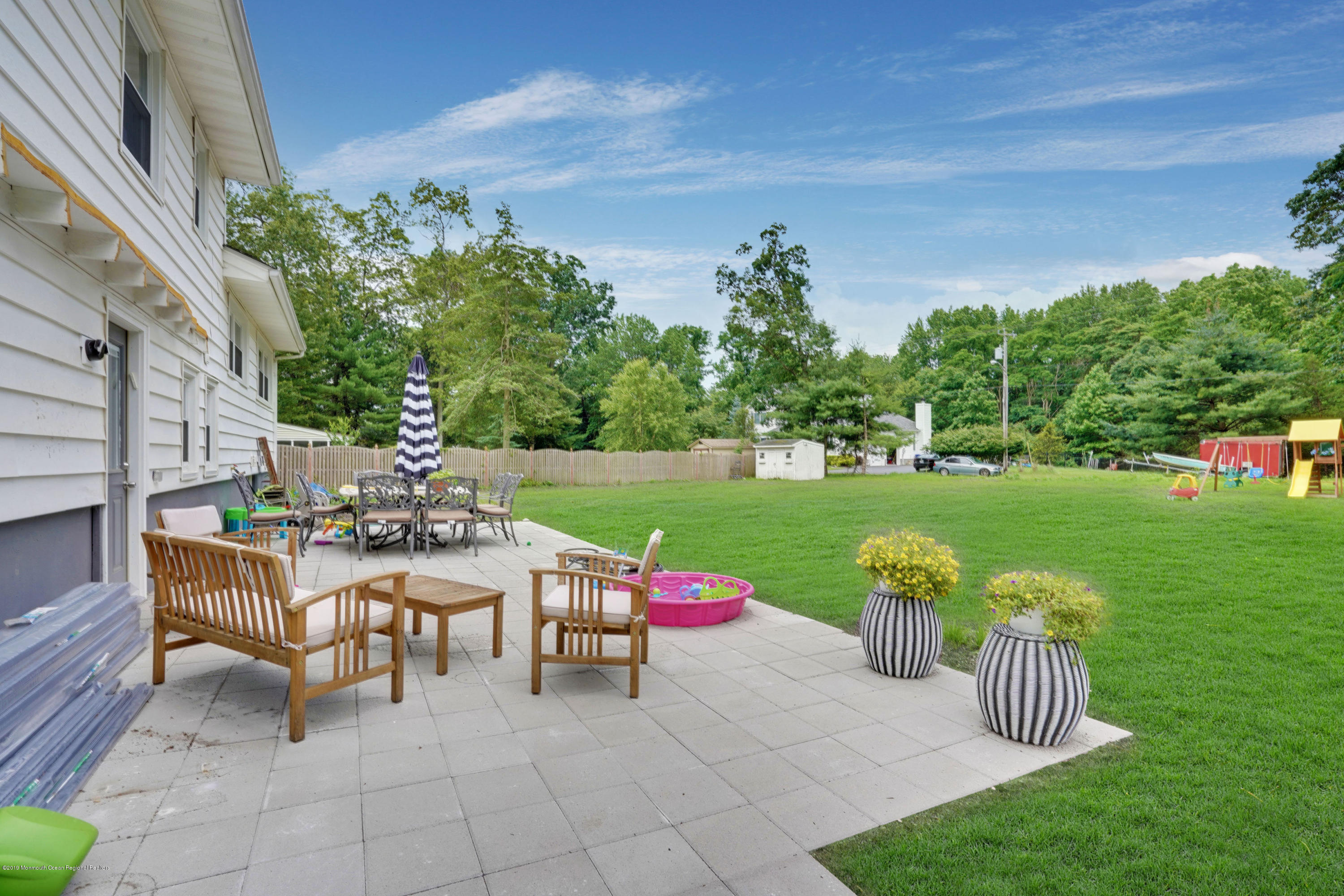 5 Ash Street Eatontown, NJ 07724 - Photo 25 of 31 a view of a chair and table in backyard of the house