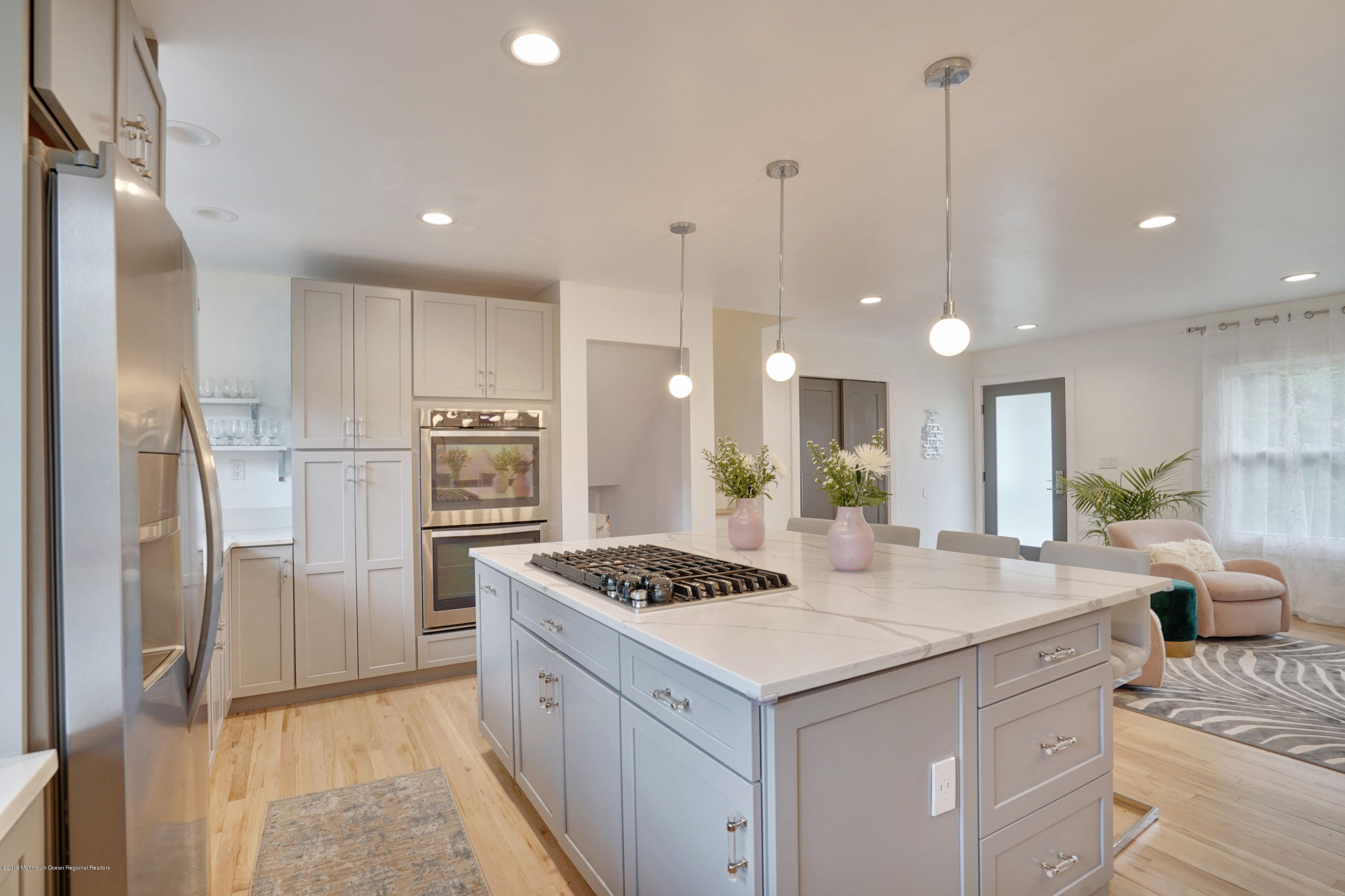 5 Ash Street Eatontown, NJ 07724 - Photo 3 of 31 a kitchen with a refrigerator a sink and white cabinets