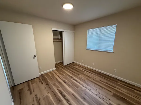a view of a room with wooden floor and closet