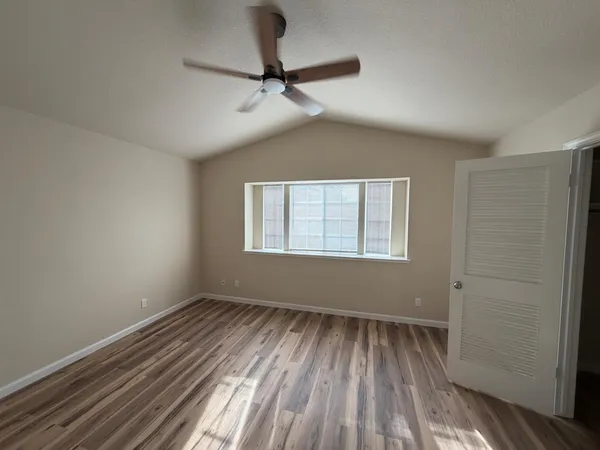 a view of room with a ceiling fan and window