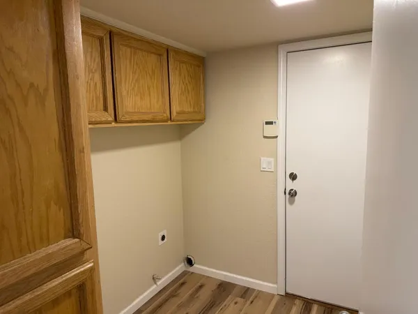 a view of front door with wooden floor