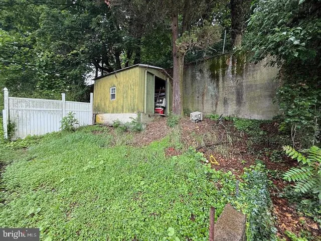 a view of a house with wooden deck and furniture