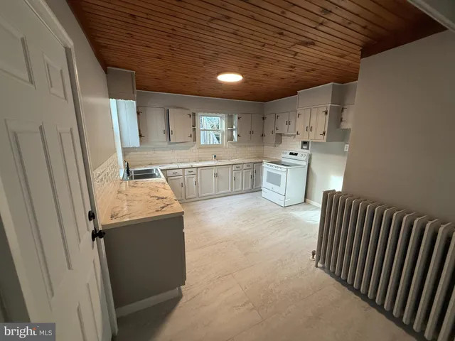 a utility room with sink dryer and washer