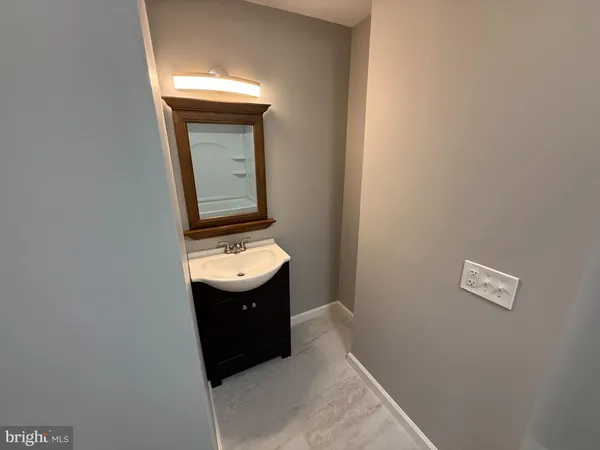 a bathroom with a sink a mirror and window