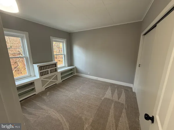 a view of room with window and hardwood floor