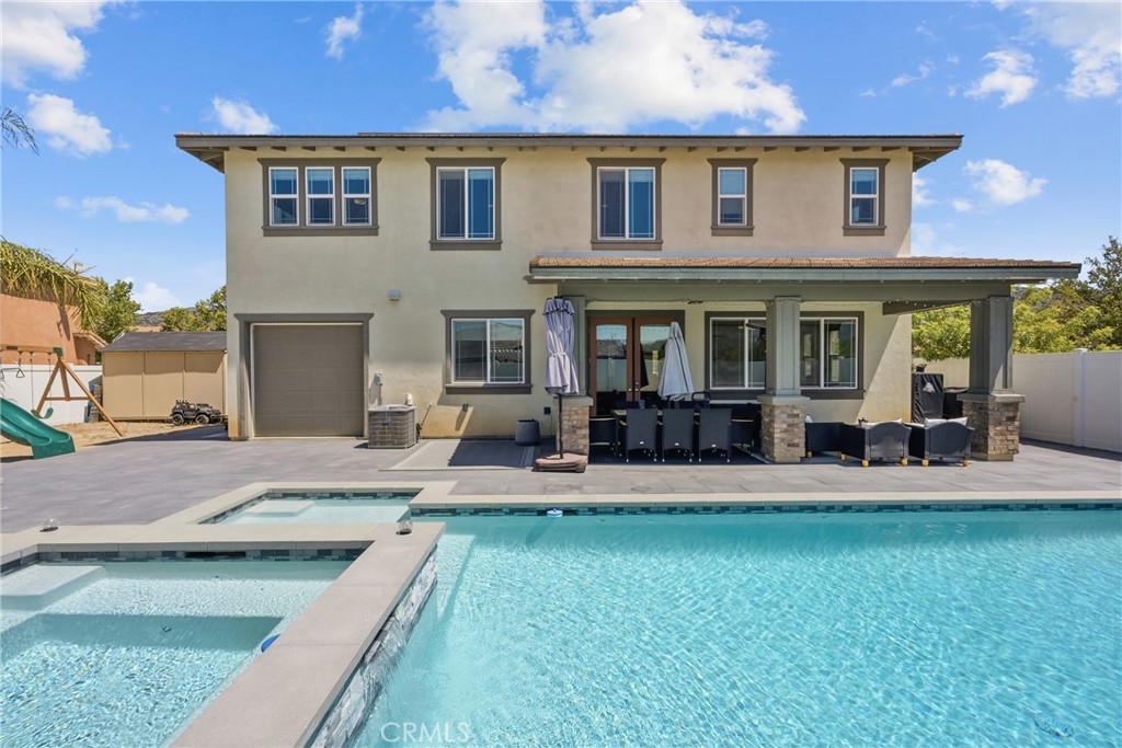 232 River Street Fillmore, CA 93015 - Photo 53 of 61 Exceptional outdoor entertaining space featuring a sparling poo, cozy firepit, ample seating areas, and a wood-burning-fireplace, perfect for or hosting gatherings year-round