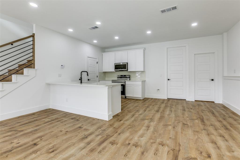 9475 Timberleaf Drive Dallas, TX 75243 - Photo 11 of 38 a kitchen with a sink stainless steel appliances and cabinets