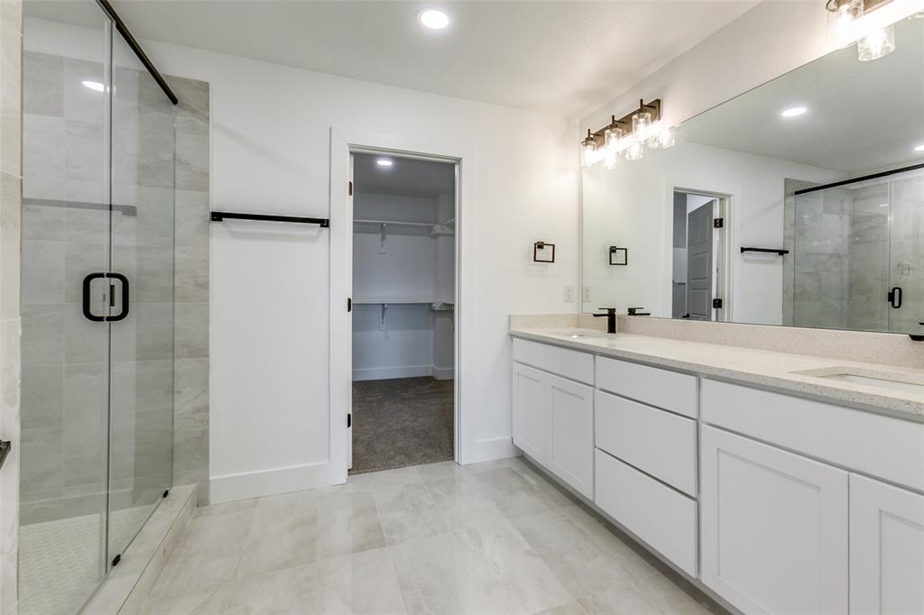 9475 Timberleaf Drive Dallas, TX 75243 - Photo 26 of 38 a bathroom with a double vanity sink mirror and shower