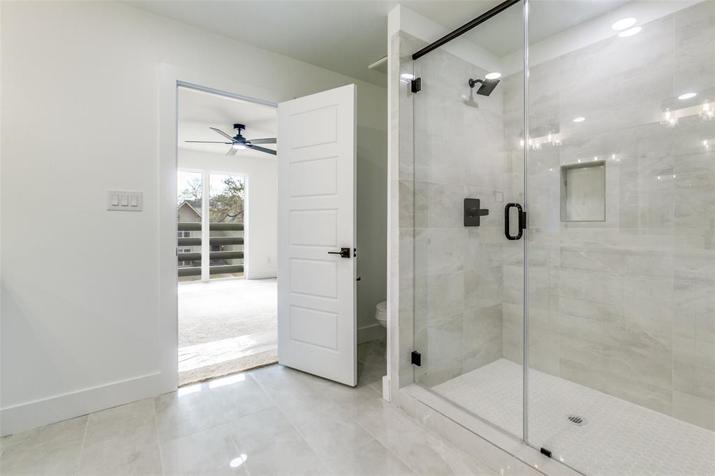 9475 Timberleaf Drive Dallas, TX 75243 - Photo 28 of 38 a bathroom with a shower and a bathtub