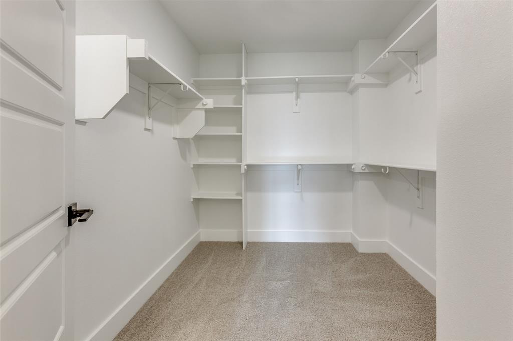 9475 Timberleaf Drive Dallas, TX 75243 - Photo 29 of 38 a view of walk in closet with empty racks
