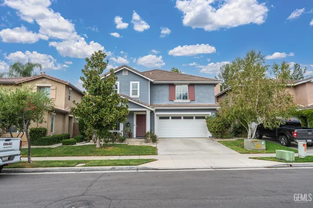 a view of a white building among the street with palm trees