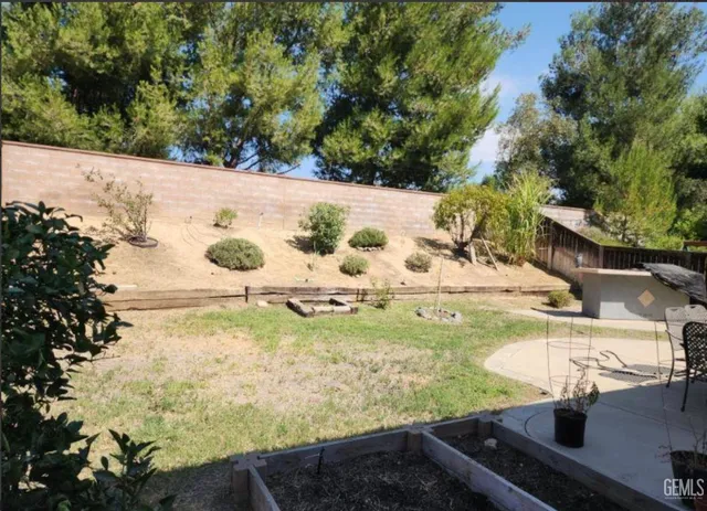 a view of a backyard of the house with a yard
