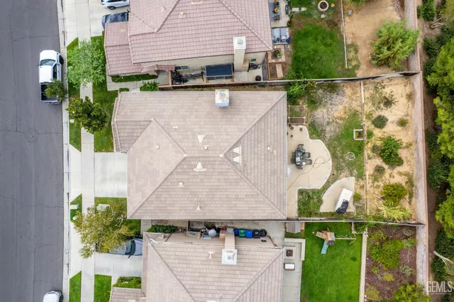 an aerial view of a house with a yard