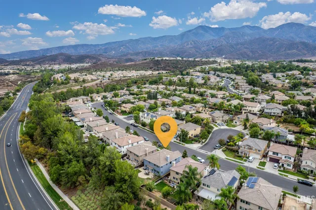 an aerial view of residential houses with outdoor space
