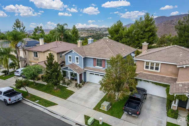 a aerial view of a house with a yard and potted plants