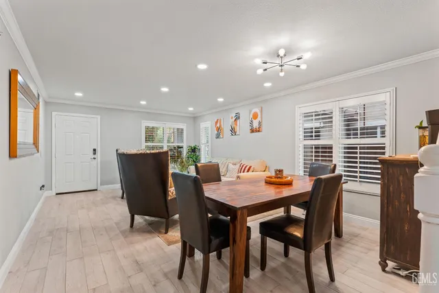 a dining room with a wooden table and chairs