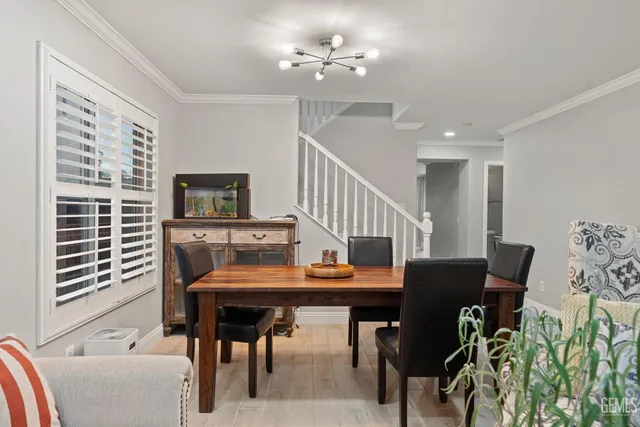 a view of a dining room with furniture and a chandelier
