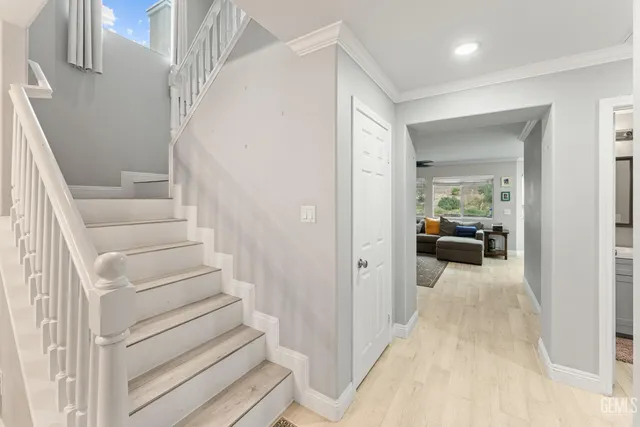 a view of a hallway with living room and stairs