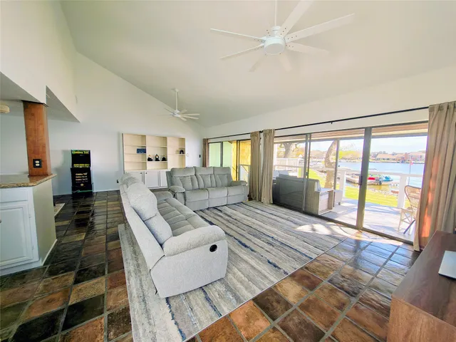 a bathroom with a granite countertop sink a mirror and a shower