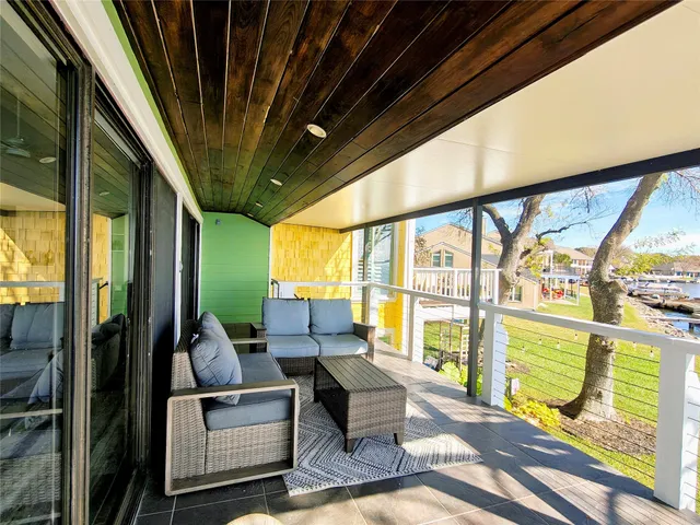 a view of a patio with table and chairs