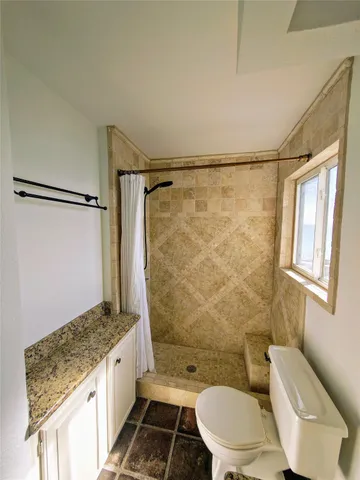 a street sign on a sidewalk next to a building