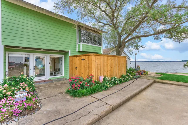 a front view of a house with a yard and potted plants