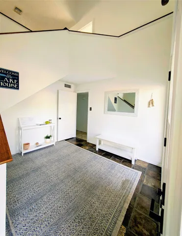 a large bedroom with a large bed and a large window