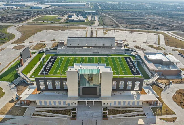 a backyard of a house with lots of green space and fountain